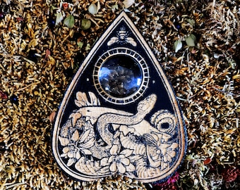 Ouija, esotericism and ouija board, planchette and spiritualism, occult art, serpent, Lilith, Cabinet of curiosities.